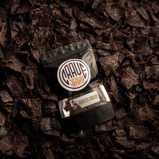 A lot of beef jerky bag with jerky on top roasted garlic flavor